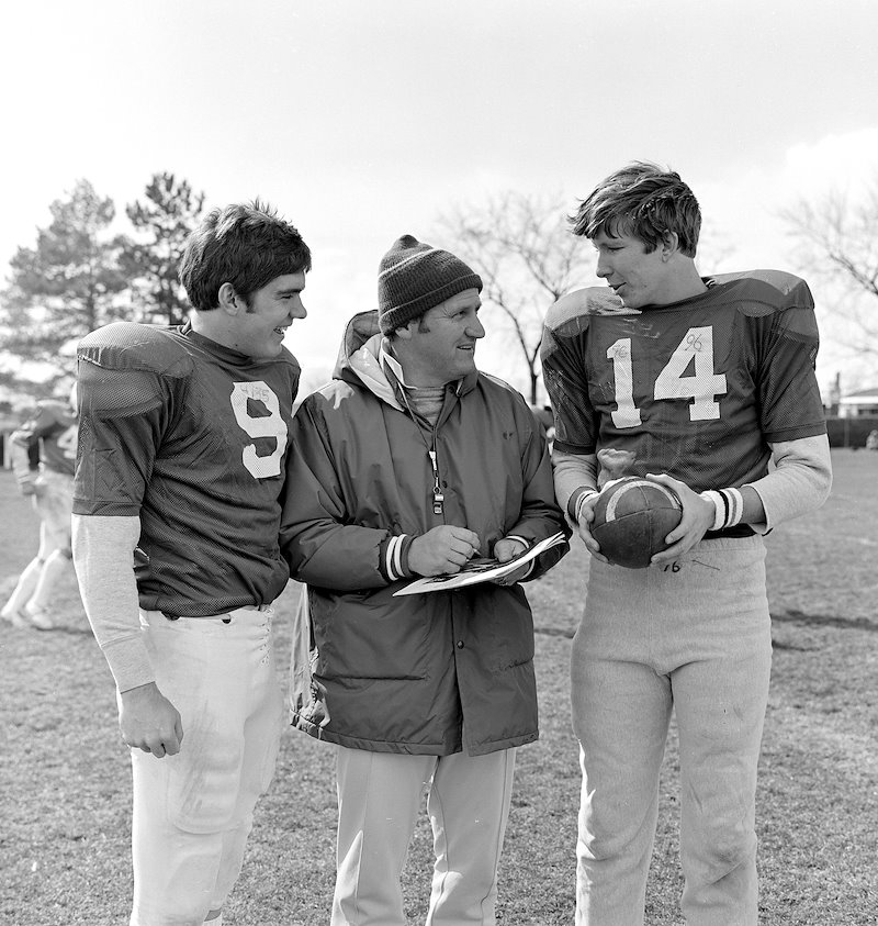 Ron Velasco and Gifford Nielson talk with coach at practice.