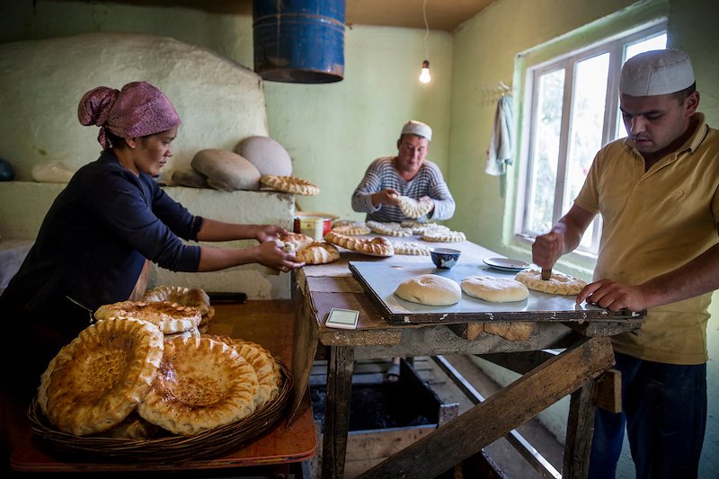 Kamilzhan Zhumaev, center, runs a bakery in Beshkent, but the bread is made with water gathered from the aryk.