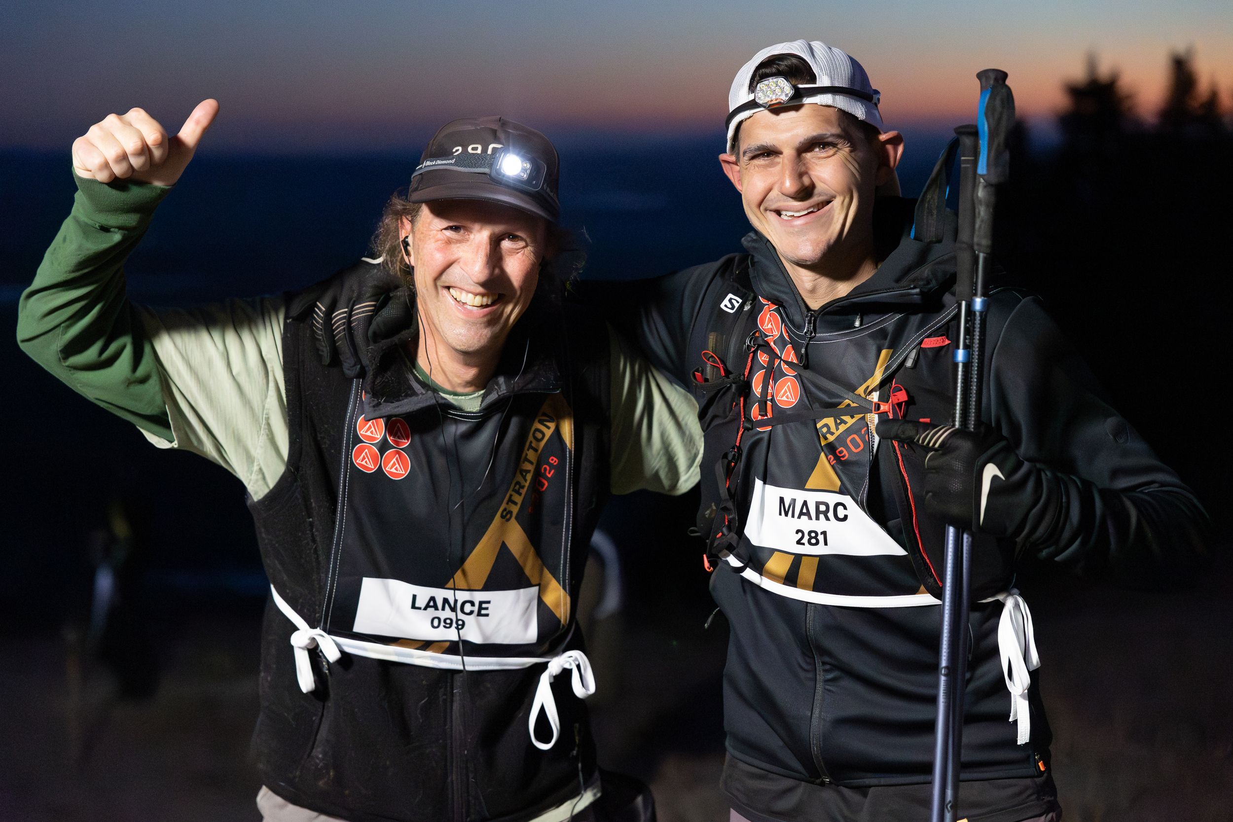 Two smiling men, Lance and Marc, pose after a race. Lance gives a ...