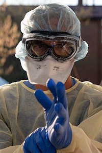 Dr. Bob pulls on his second pair of gloves.