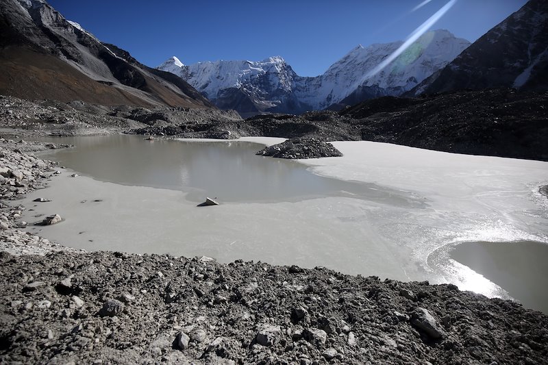 The glacial lake, part of it is now seen frozen, is spread in an area of 1.28 sq km and 148.9 meters deep.