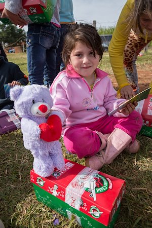 One girl received a teddy bear holding a heart. In her other hand is The Greatest Gift Gospel booklet, which tells her how Jesus’ love.