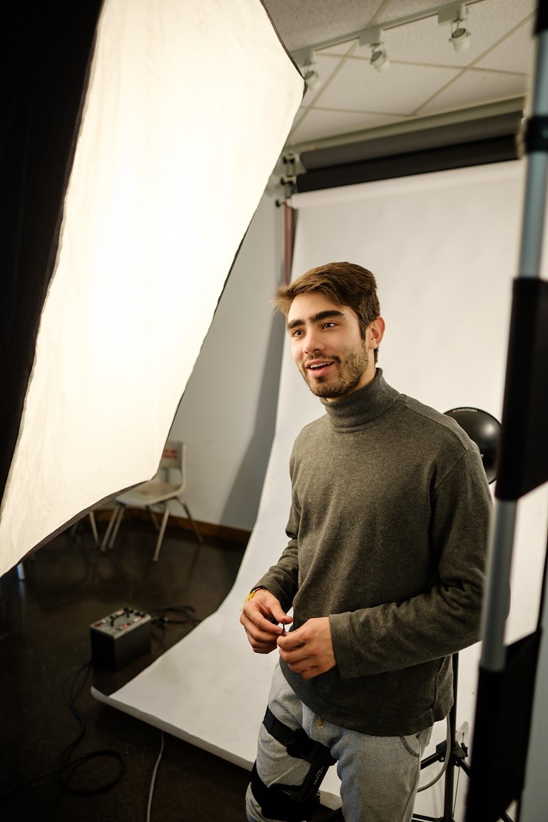 Andres Gonzalez ('17) poses for a portrait in the makeshift photo studio inside Scales.