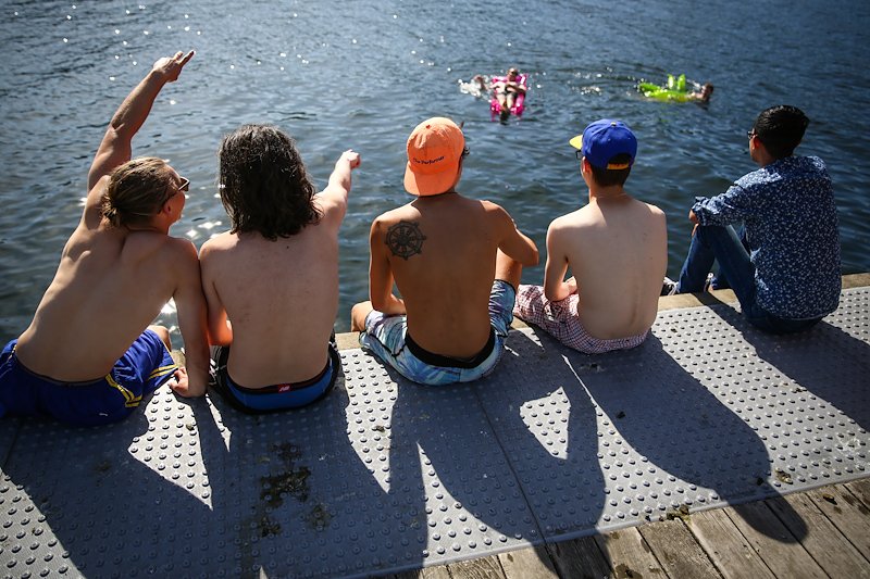 People enjoy the sun on Lake Union.