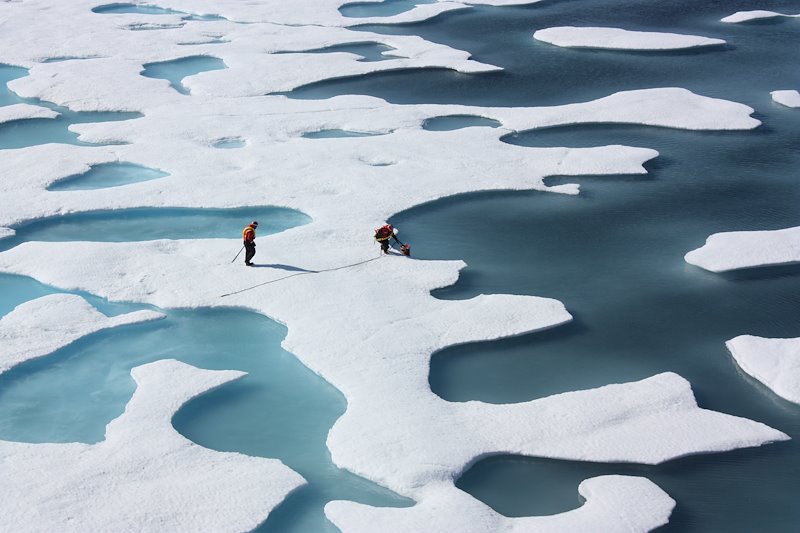 Two scientists study how changing conditions in the Arctic affect the ocean's chemistry and ecosystems. Photo by Kathryn Hansen, NASA.