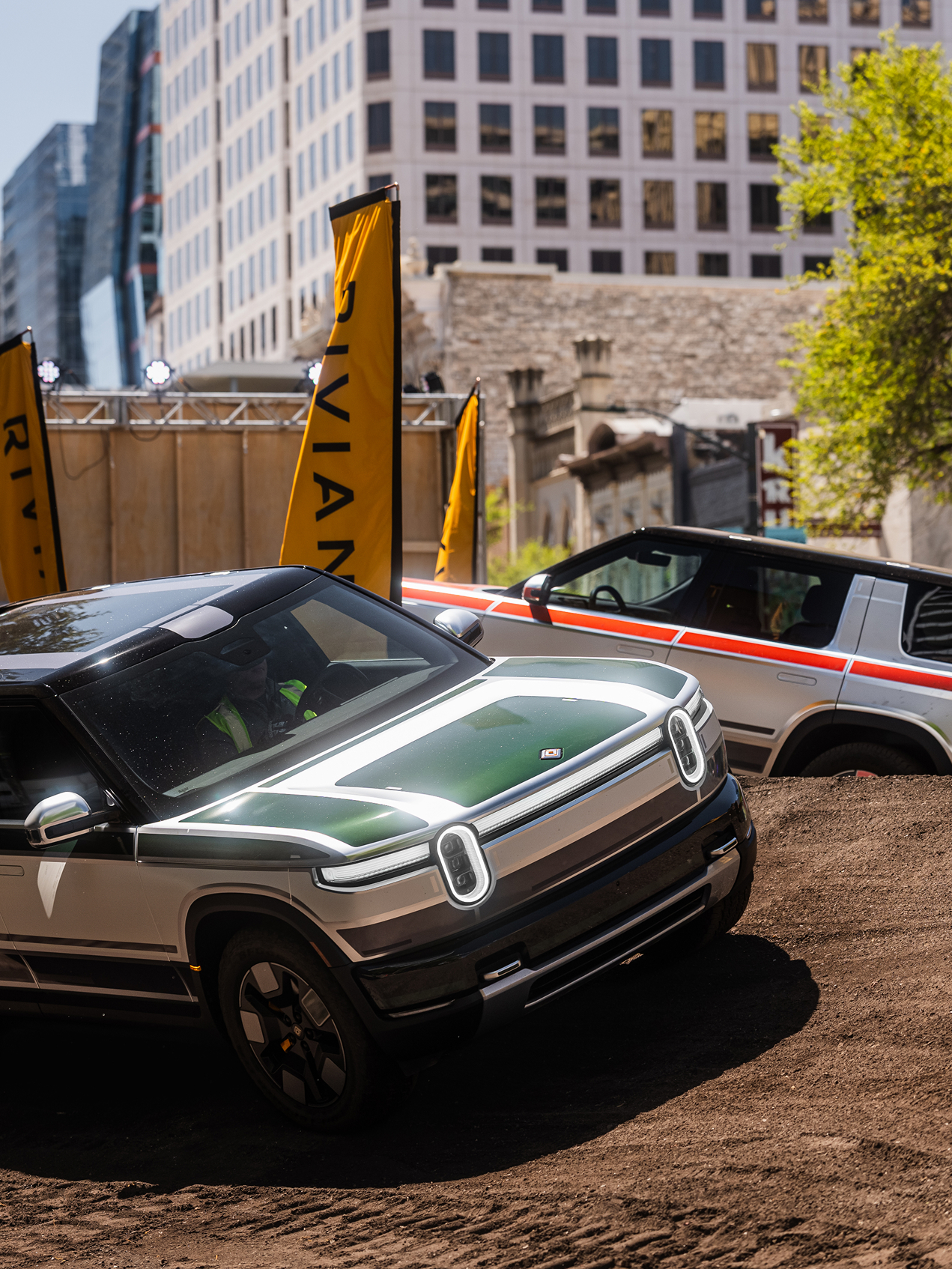 Rivian vehicles on a dirt track at SXSW 2026. The front vehicle is ...
