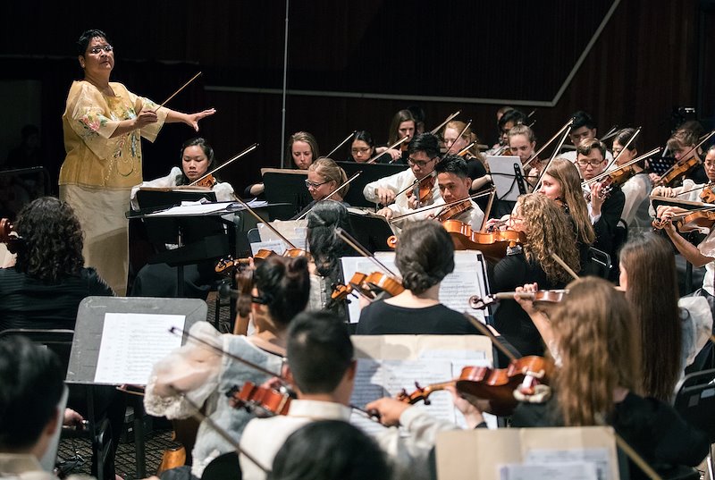 Professor Michi Martinez directs the combined orchestra. Photo by Jaren Wilkey/BYU