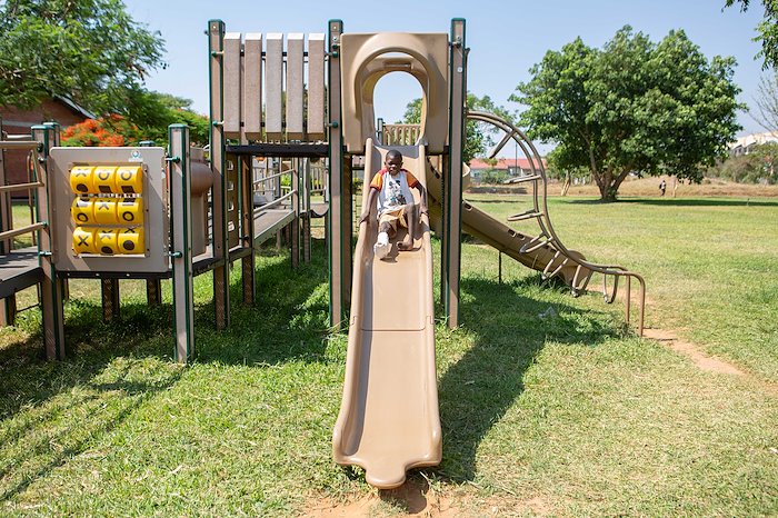 Enock found a great place to play at our new playground.