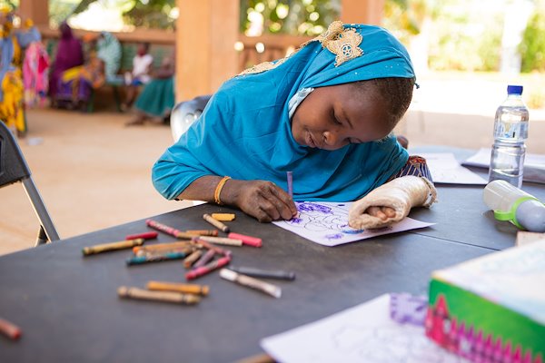 Souraya got to color and learn how God loves children while she waited for her appointment with the doctor.