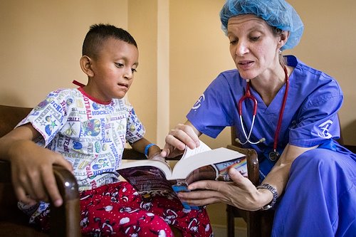 Antony, 7, receives his own Bible to take home after surgery.