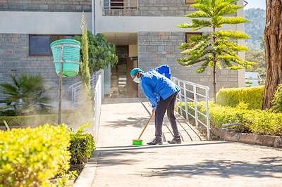 Peter is helping to keep our hospital compound clean.