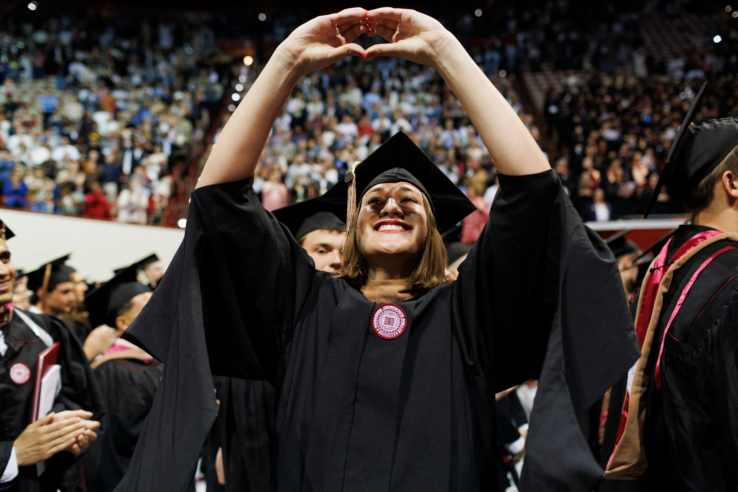 A graduate signals to the audience during the IU Bloomington Graduate ...