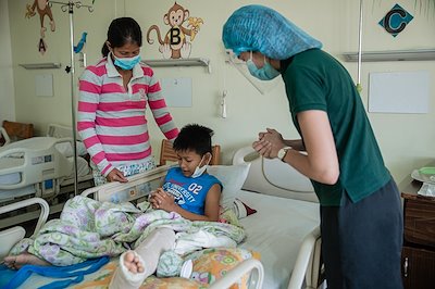 Child Mentor Patricia prays with James for his speedy recovery.