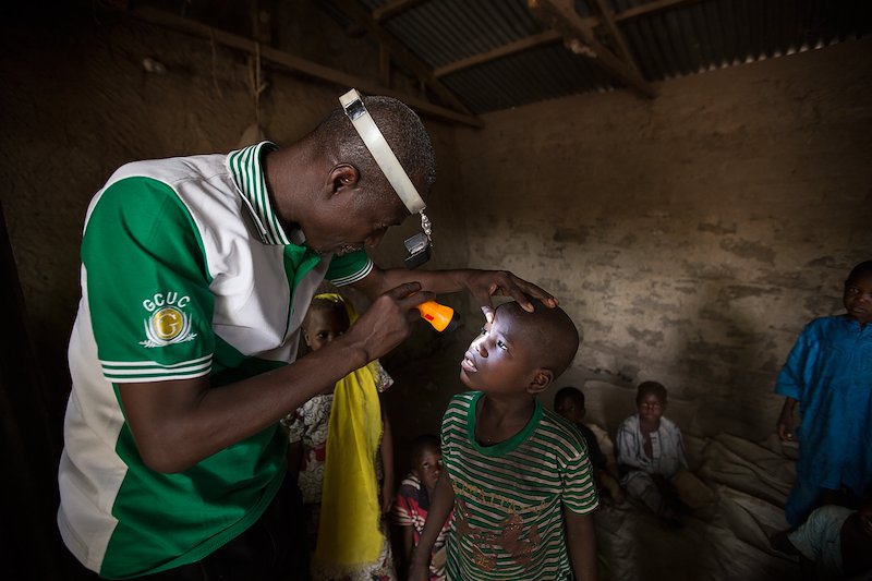 Aliyu examines a young boy in a village school in Gwadabawa local government area, Sokoto state.