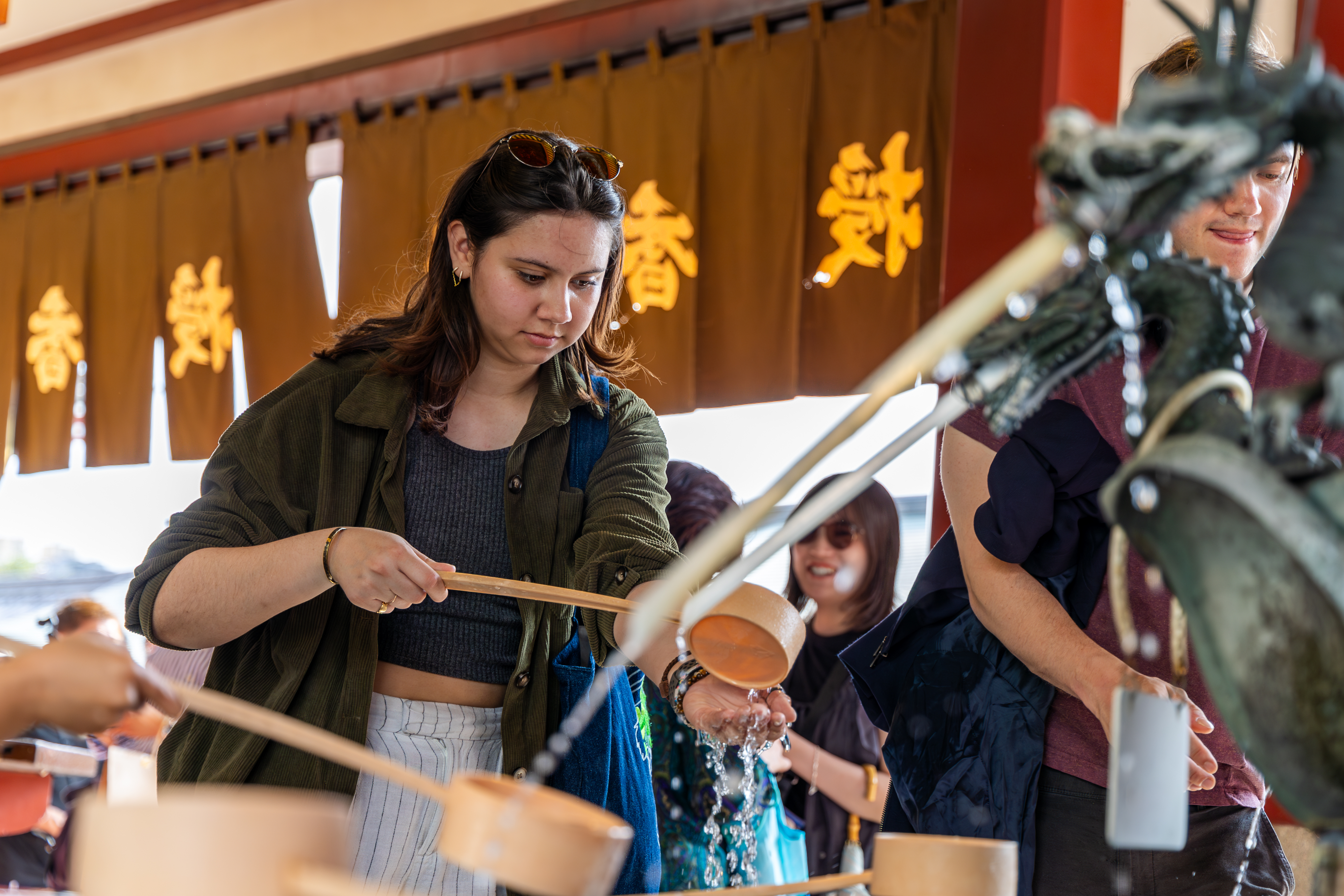 Students partake in a ceremonial purification ritual known as chōzu at ...