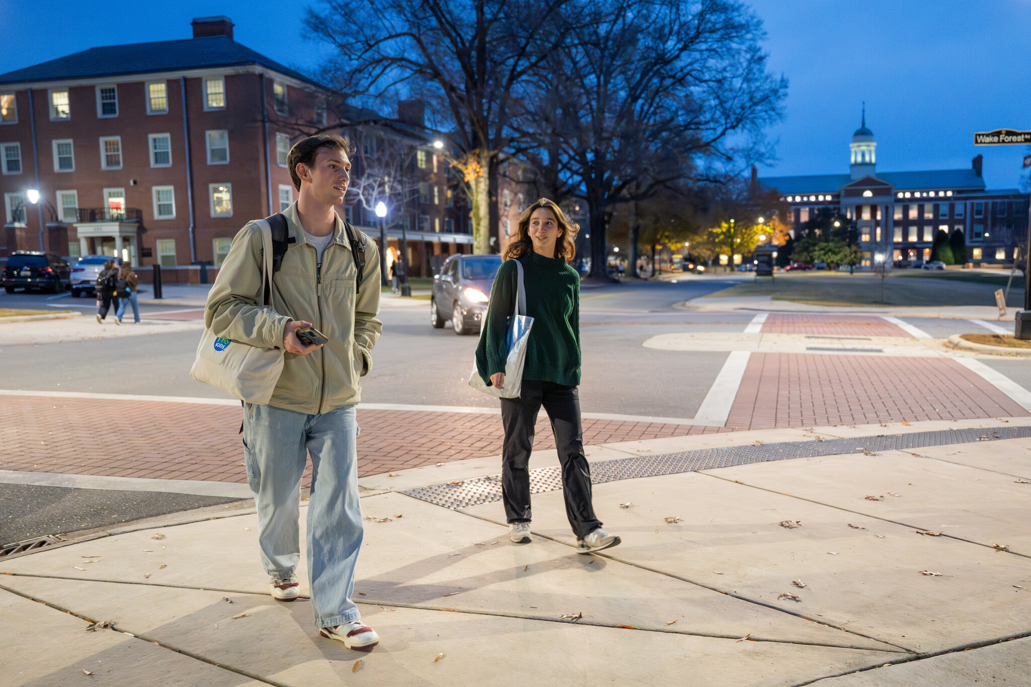 Caleb Walsh walks across a brick-paved crosswalk on Wake Forest's ...