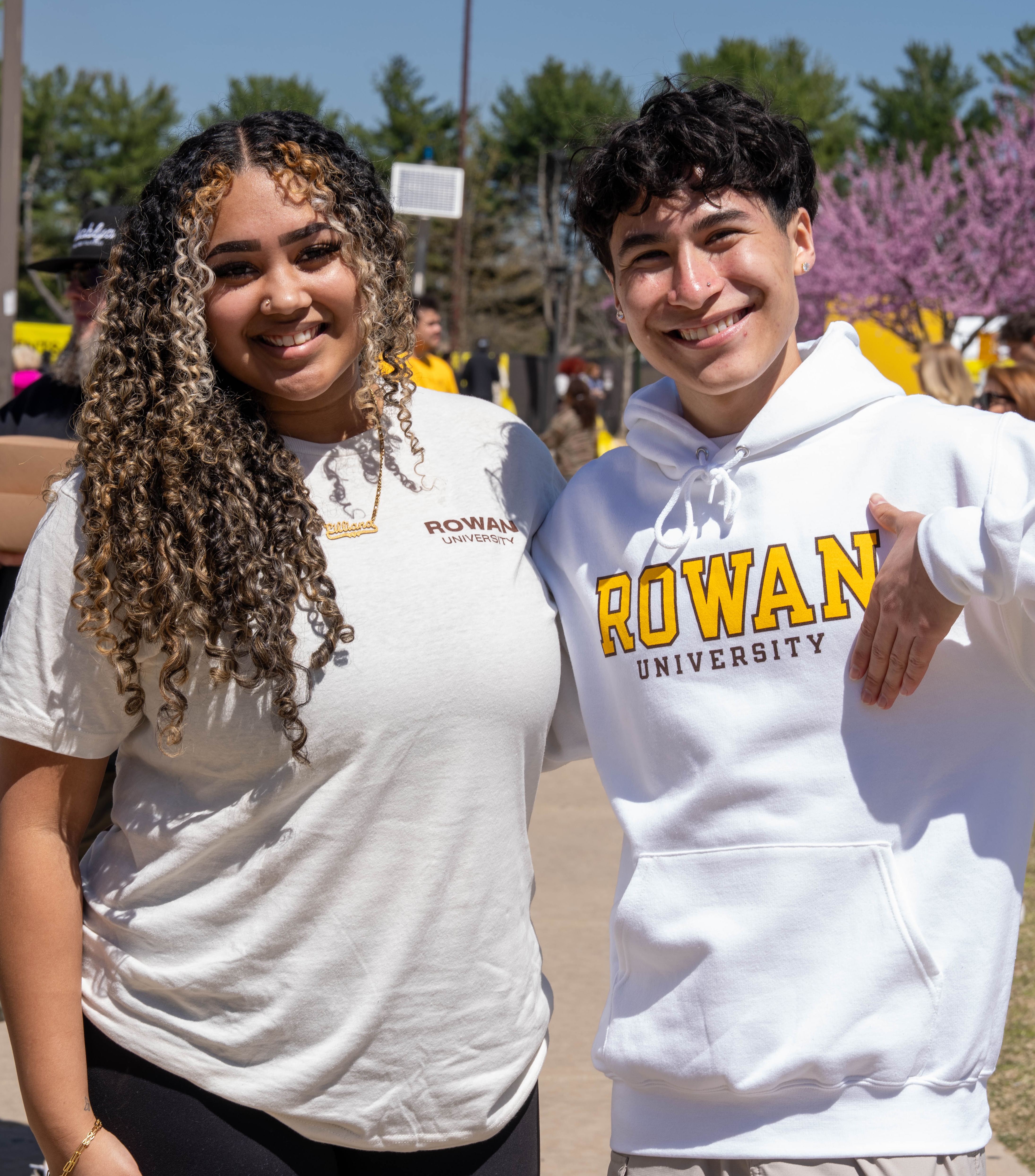 Two smiling Rowan University students pose outdoors. The student on the ...