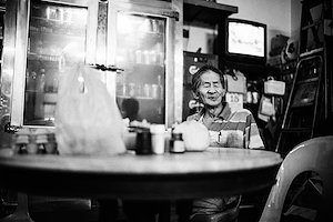 he comes in and buy three ciggies from the younger shi, lights one immediately and keeping the other two in his front pocket for later.
