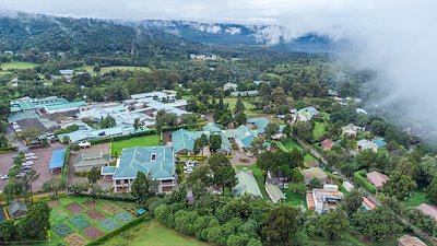 An aerial perspective of CURE Kenya on a foggy day.