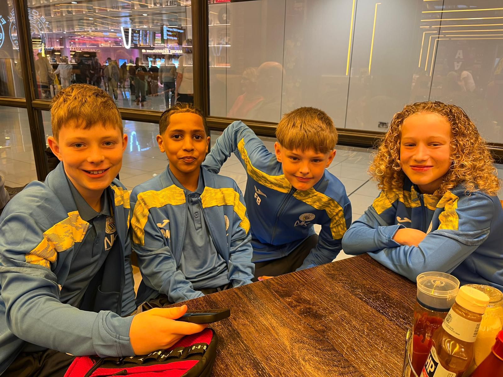 Four Fletcher Moss Rangers players sit at a table, smiling at the ...