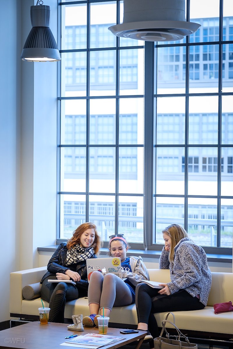 Working with a silver lamé winter boot are, from left, Isabel Lafortezza ('19), Kaela Griswold ('19), and Morgan Powers ('19).