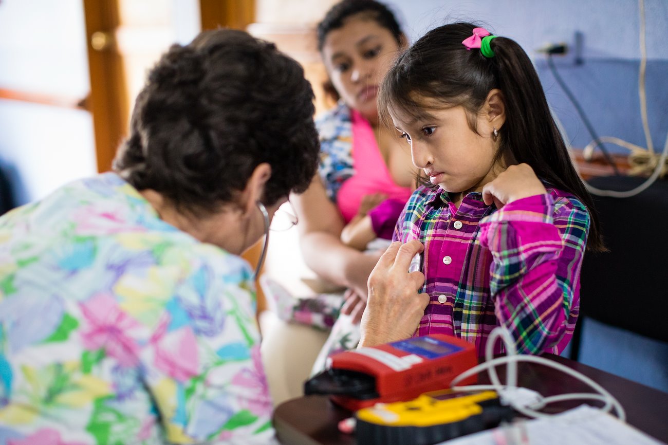 Nurse Susan Michaud, born with a cleft lip, provides a unique sense of encouragement  to 7-year-old Ailyn as she prepares for her cleft lip and palate surgery.