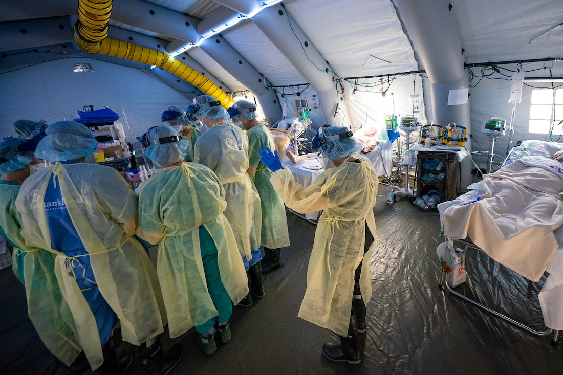 Staff pray during their shift in the ICU in Cremona.