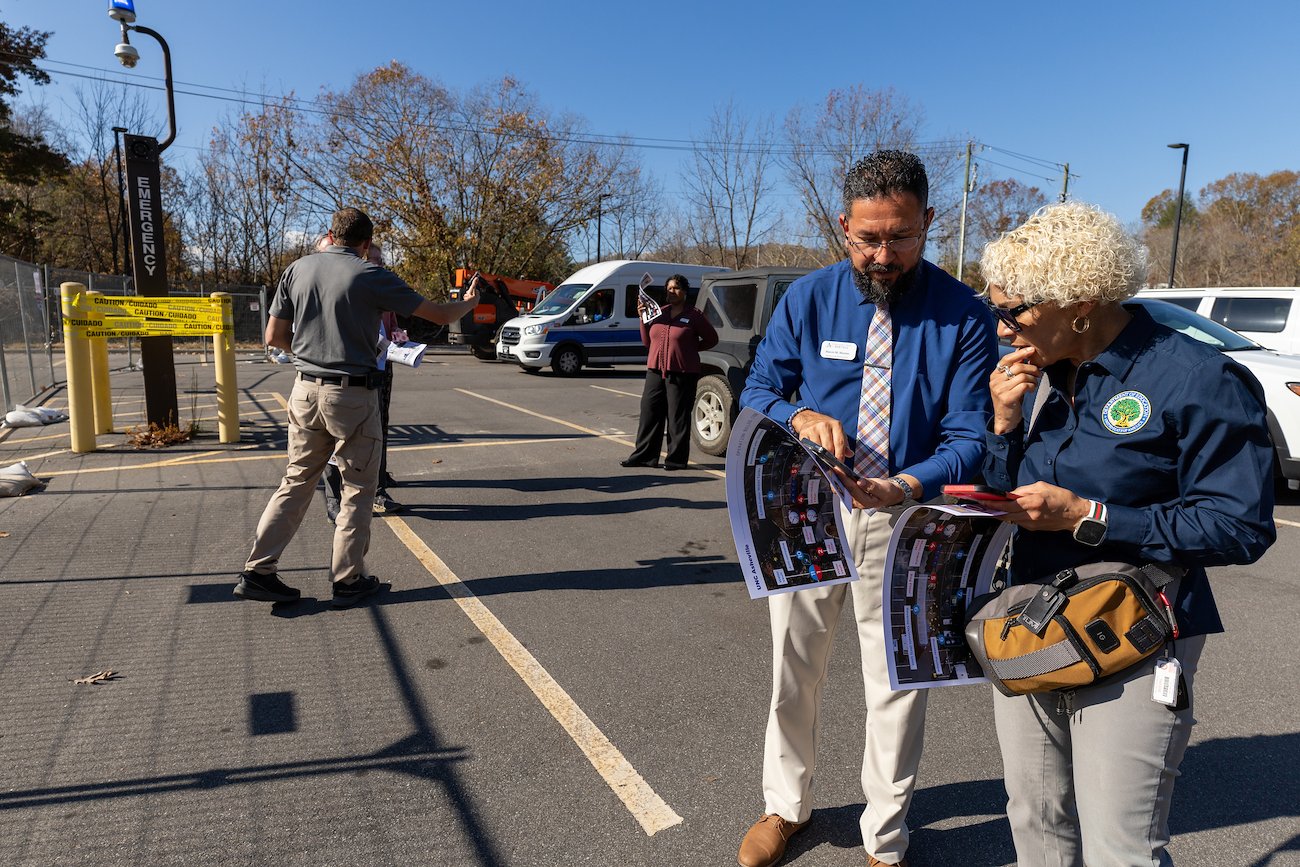 Associate Vice Chancellor of Admissions and Financial Aid Marcio Moreno (front left) and Ingrid Valentine (front right) discuss the water treatment system.
