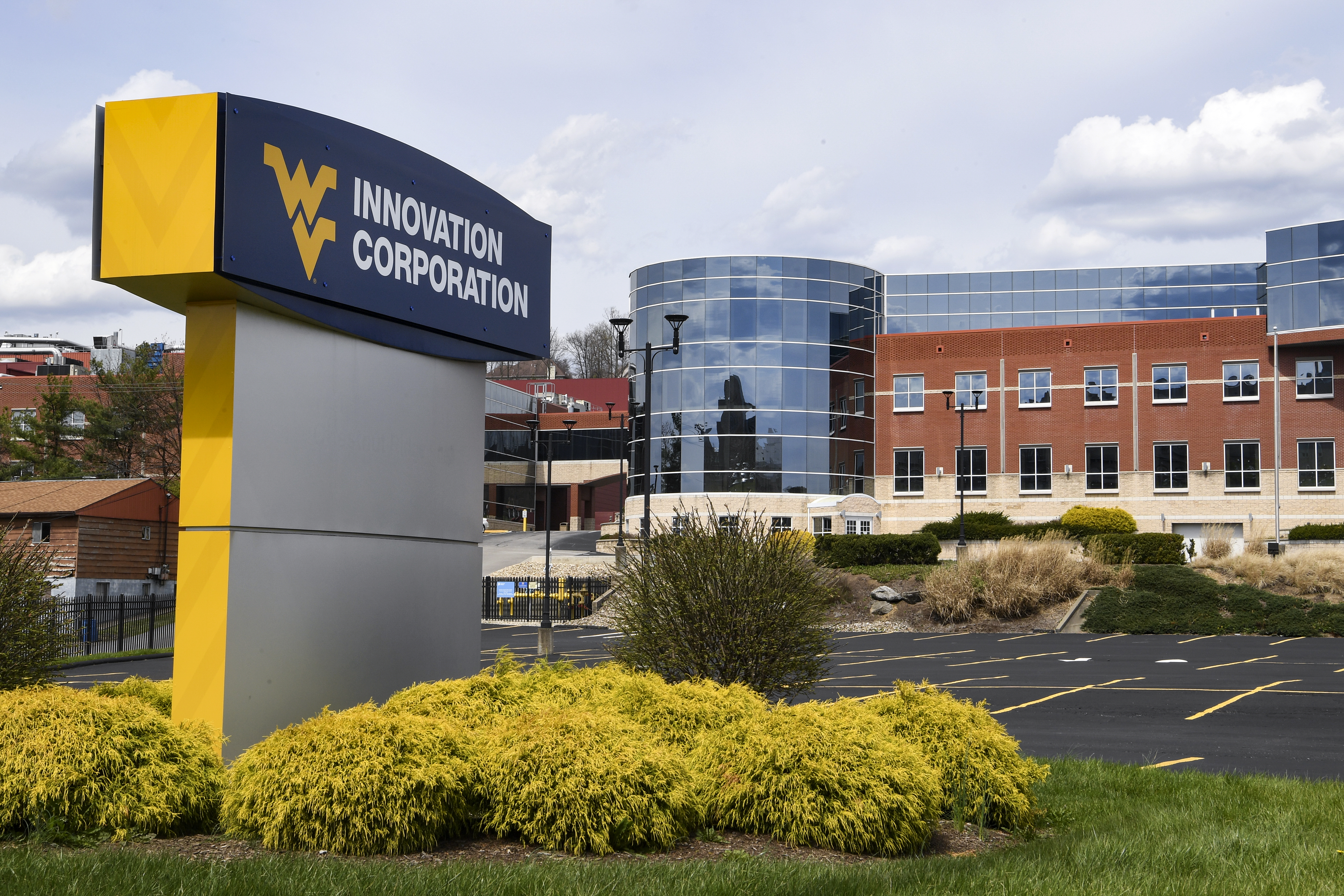 WVU Innovation Corporation signage in front of a brick and glass ...