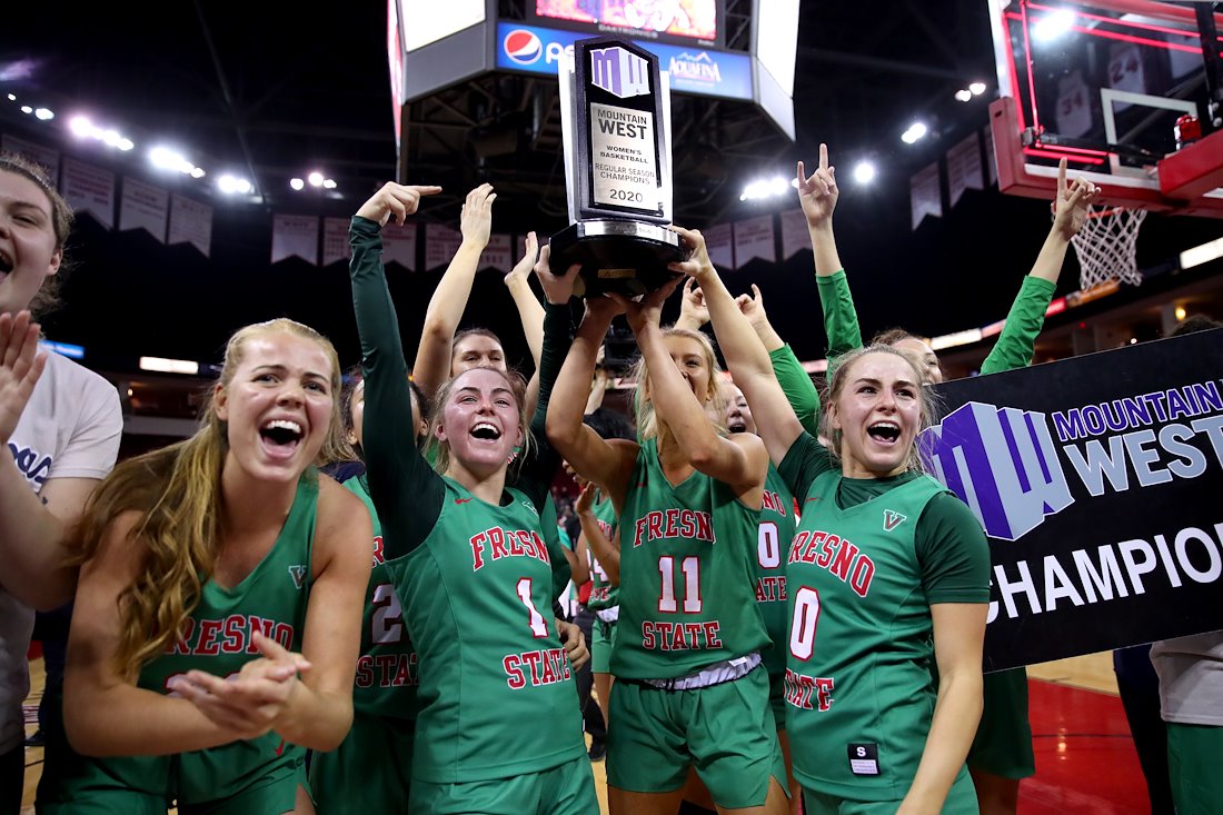 Members of the Fresno State women's basketball team celebrate after they defeated the San Jose State Spartans to win their first ever Mountain West Conference Championship.