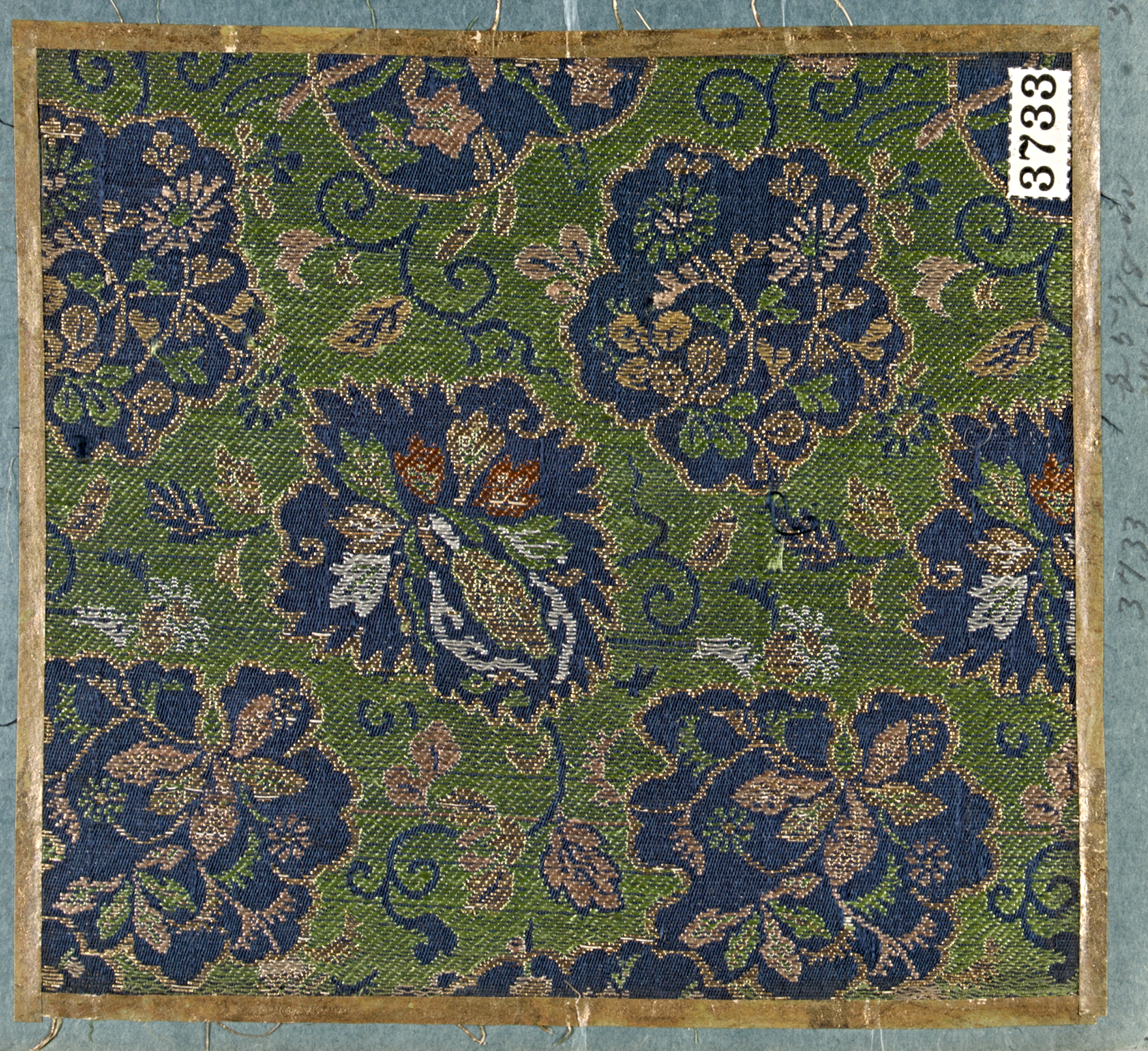 Sample of woven Japanese textile with floral pattern in green, navy ...