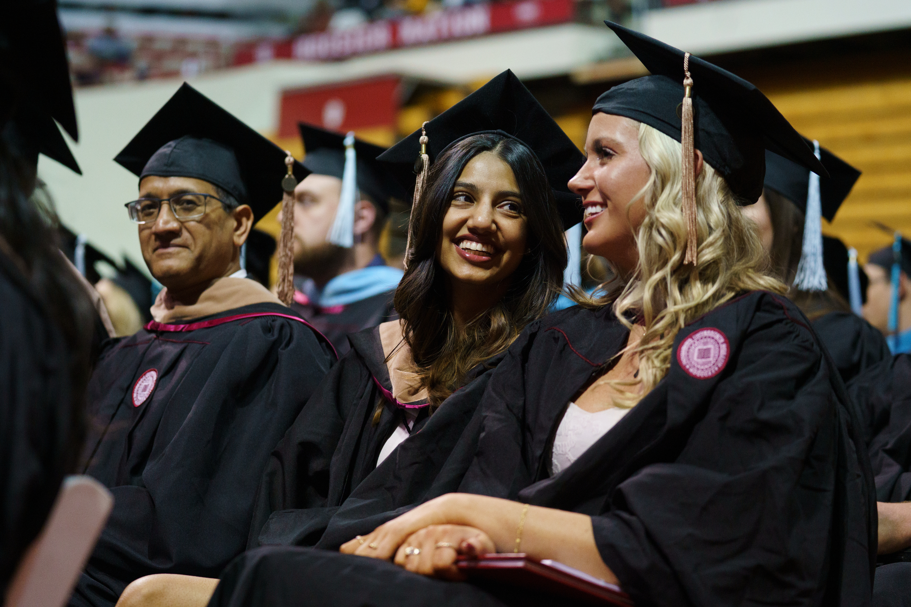 Graduates share a laugh during the IU Bloomington Graduate Commencement ...
