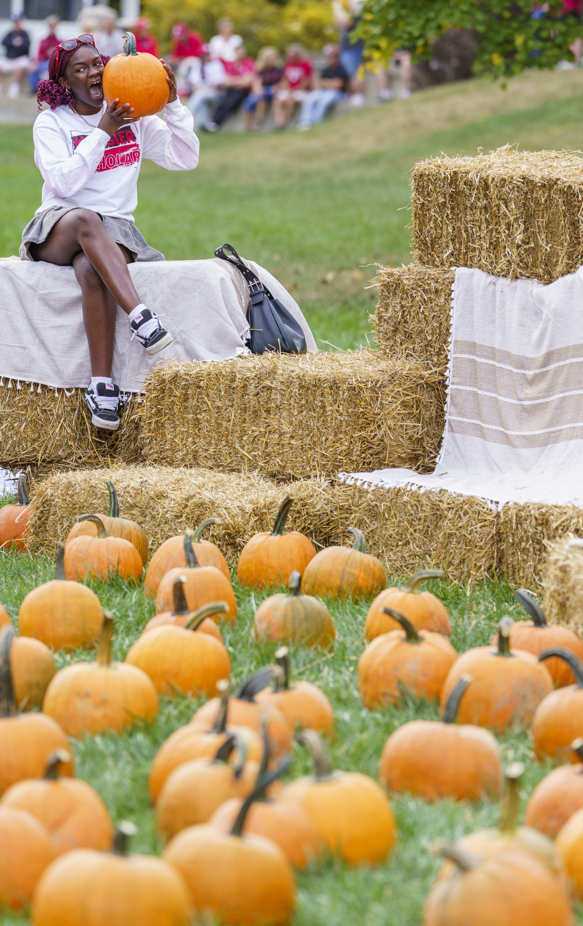 Hannah Obajolu playfully chomps at a pumpkin during the Indiana ...