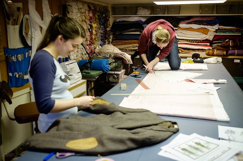 Alyssa Gera, right, cuts out patterns in the costume shop inside Scales Fine Arts Center.