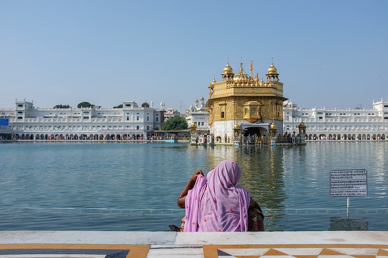 A lady bathing in the holy water at the Golden Temple.