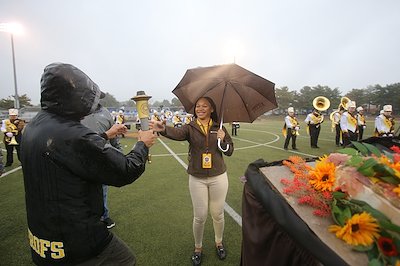 and, at midfield, Houshmand presenting it to Student Government Association President Brianna Reagan, a senior.