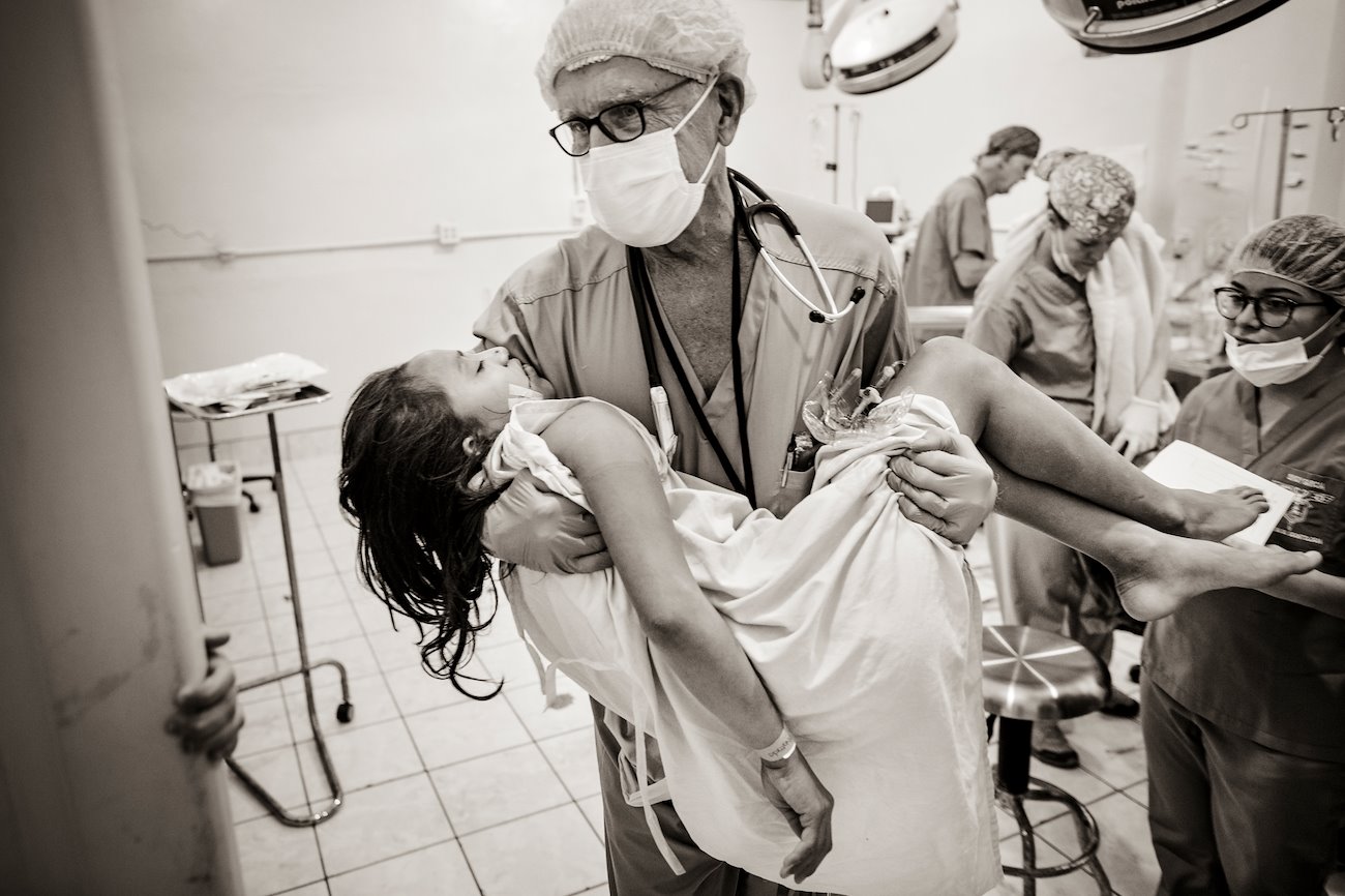 Jeylin is carried to the recovery room after Samaritan’s Purse medical staff performed her cleft lip and palate surgery.