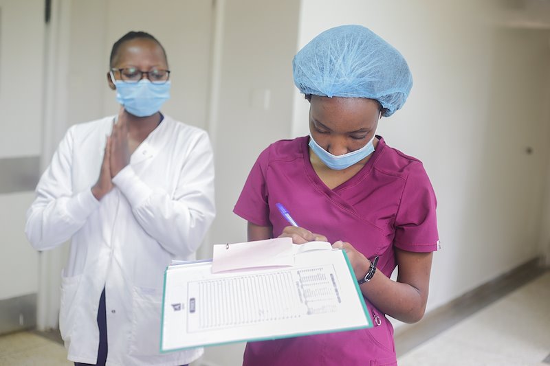 Nurses Jacinta (front) and Mary (at the back) clearing patients for surgery.