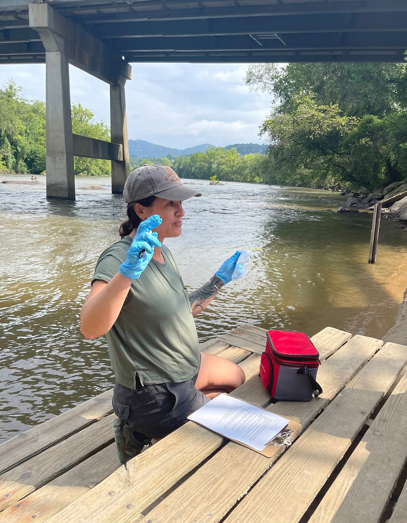 Kari Kvittem explains the water sampling process at the French Broad River.