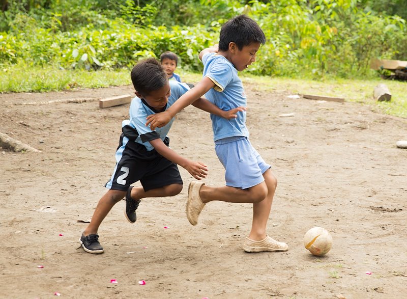 Children play with a soccer ball in Tena, Ecuador.
