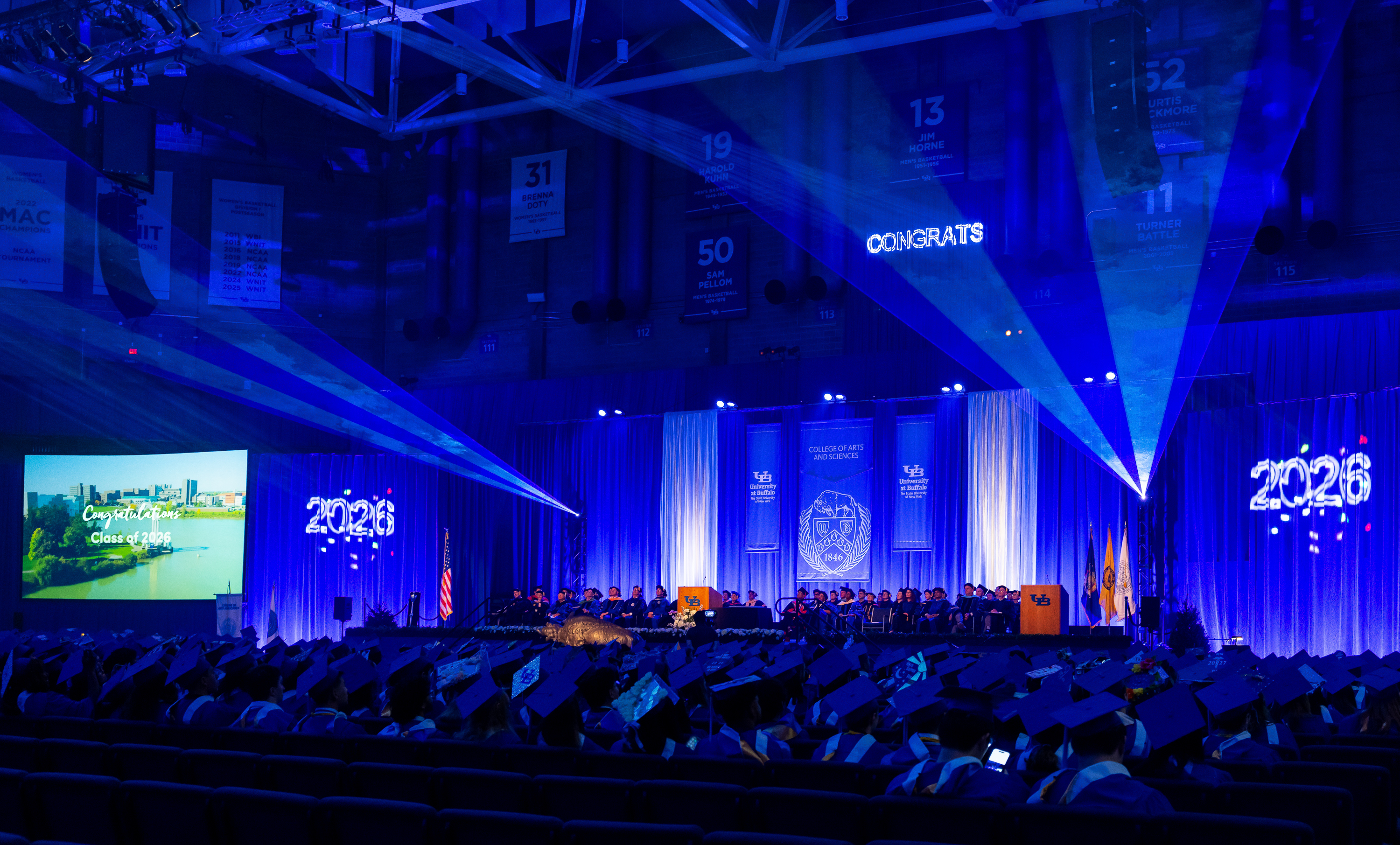 Graduates sit in the audience space in rows at a University at Buffalo ...