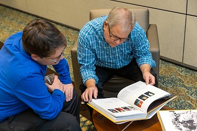 Ian Von Franzke ’21 and Andrew Von Franzke leafed through the book commemorating the institution they've been part of for more than 17 years.