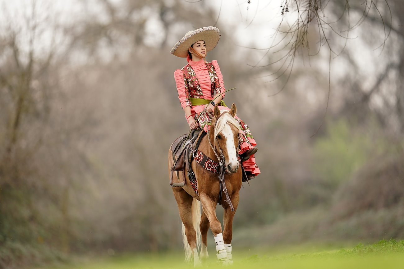 Equine science major Annabelle Ortega rides a horse near her hometown of Winton, CA.