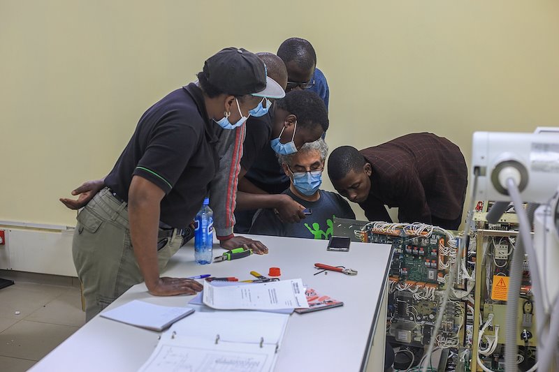 CURE Bio-Med Team installing the new X-Ray machine.