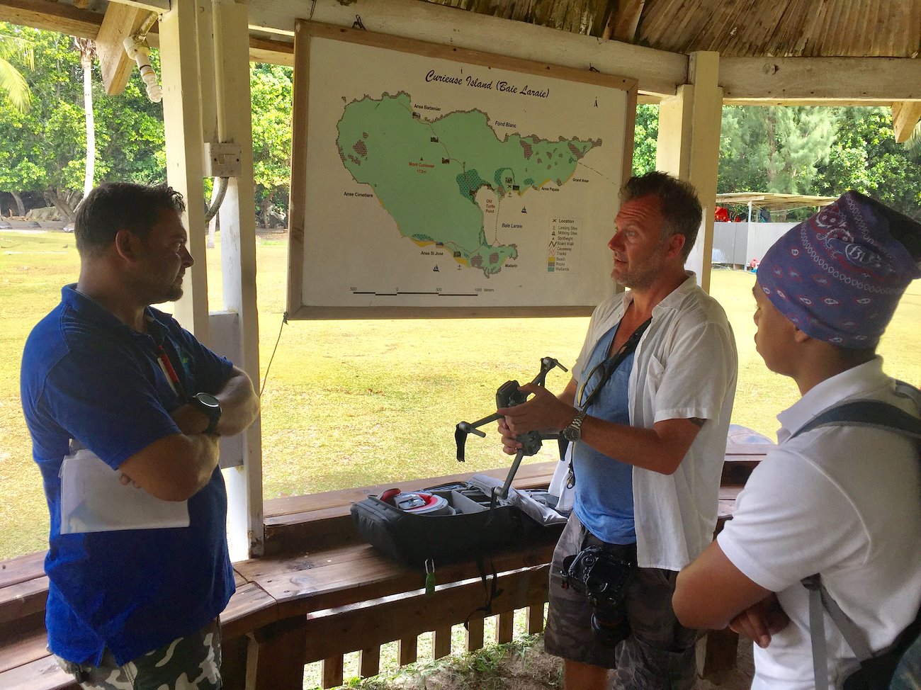 GRID-Arendal’s Rob Barnes, Ranger Jason Bastille and a representative from the Ministry of Environment, Energy and Climate using a map of Curieuse Island National Marine Park to plan a test mission. Credit: Valentin Emelin, GRID-Arendal