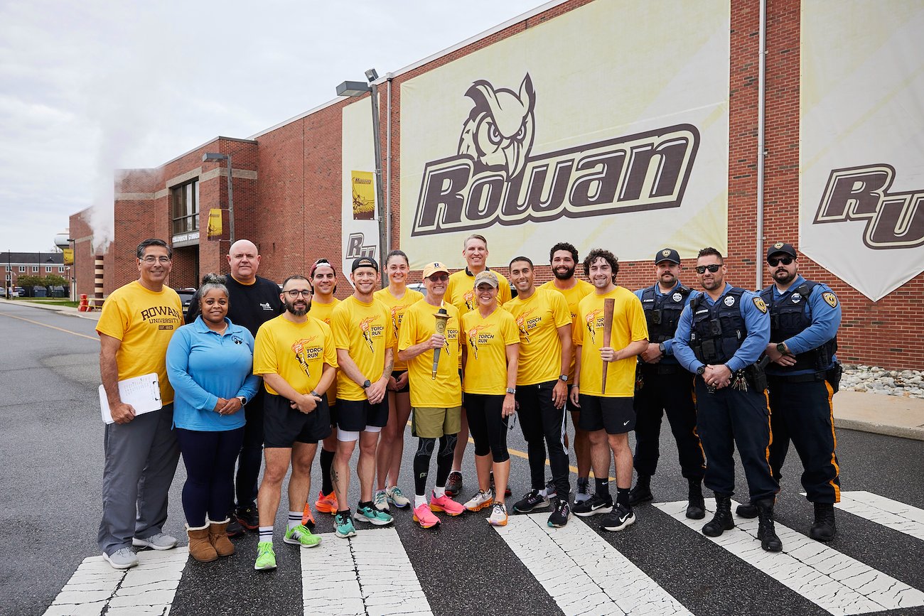 Runners celebrated with (from left) run organizer Joe Cardona, driver Kellyn Hubbard, Wellness Center director Scott Woodside and Public Safety officers Michael Welding, Russell Carmolingo and Austin Ramos, all of whom accompanied them on the route.