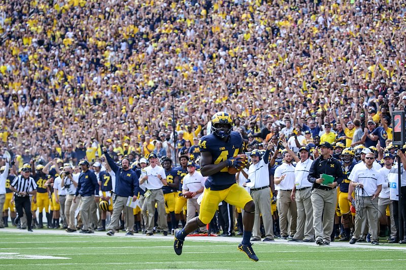 Michigan Stadium erupts after Delano Hill makes an interception and returns it for a touchdown.