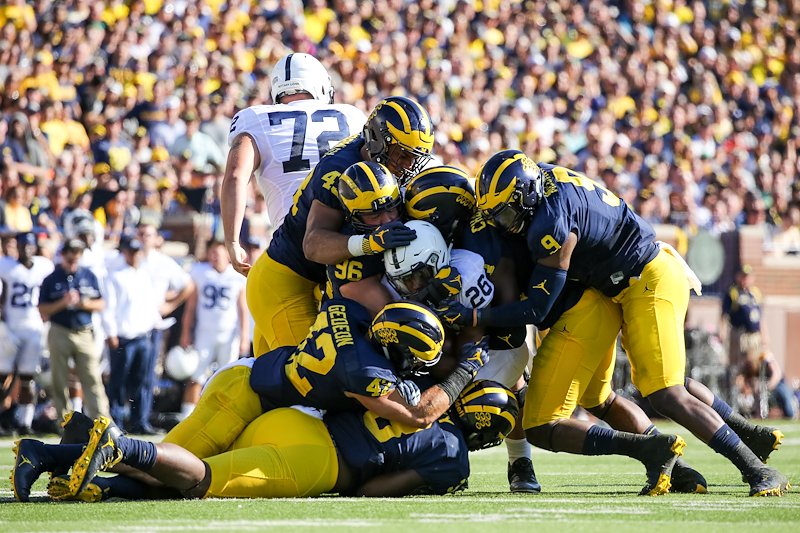 Six Michigan defenders meet at the ball to make the stop.