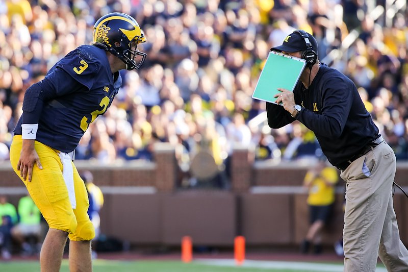 Coach Harbaugh talks strategy with Wilton Speight.