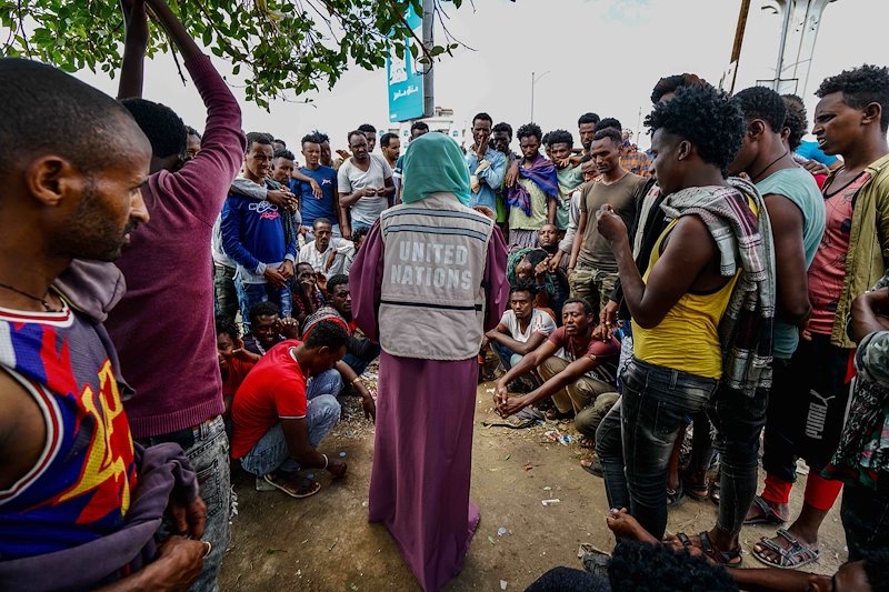 A local OCHA staff member meets with migrants and refugees at a former football stadium in Aden. Many tell stories of kidnapping, extortion and prolonged imprisonment.